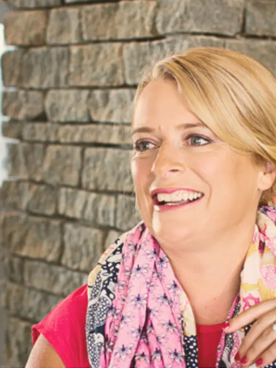 melanie wheatley smiling with a scarf around her neck
